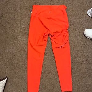Redish orange elastical leggings.